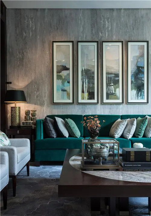 stylish grey living room with textural touches and an emerald sofa
