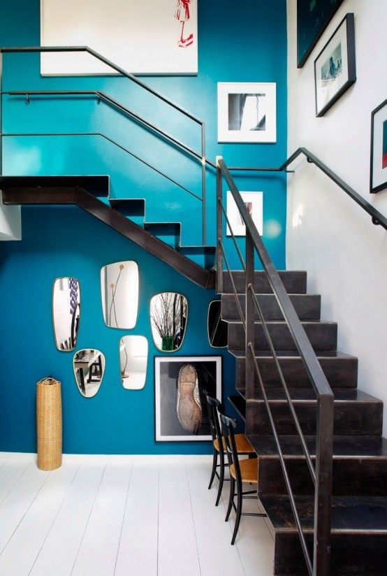 bold blue wall with artworks to make the space chic