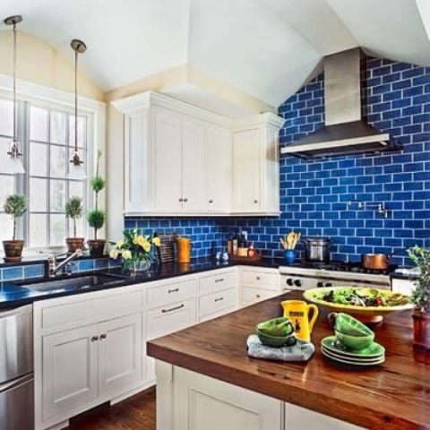 bold blue subway tiles to make the cabinetry look fresher and add color to the kitchen instantly and make it cooler