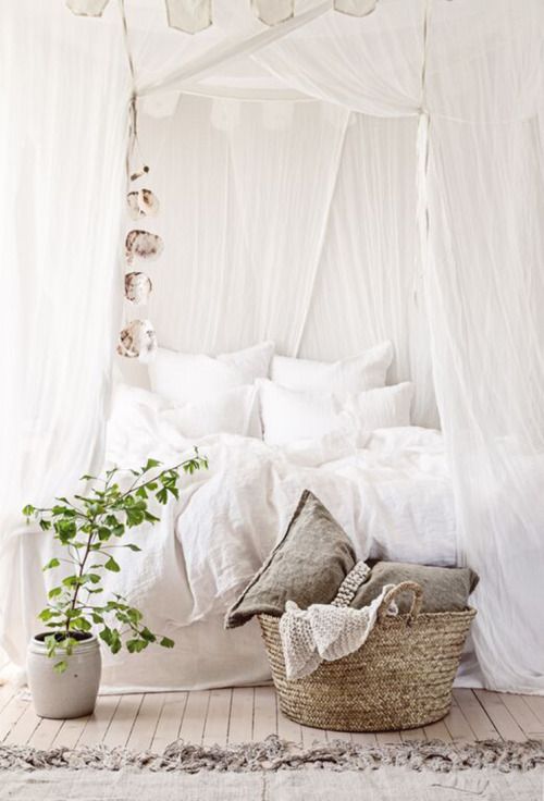 rustic bedroom with crispy white draperies over the bed