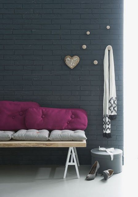 black brick wall made up with wall panels decorated with wooden pieces
