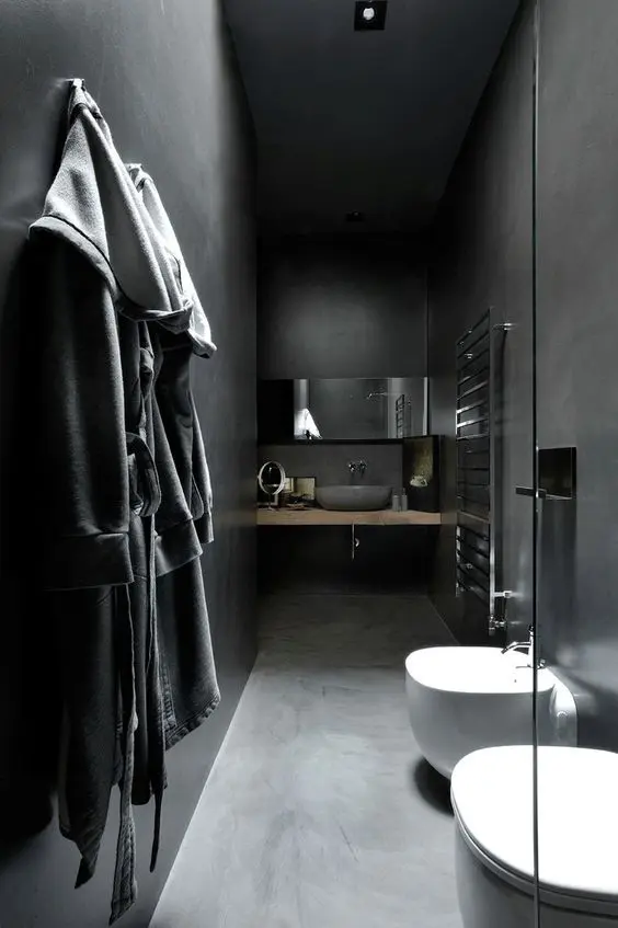narrow minimalist bathroom with tiled walls and floors