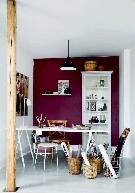 purple accent wall in a white craft room makes a bold statement