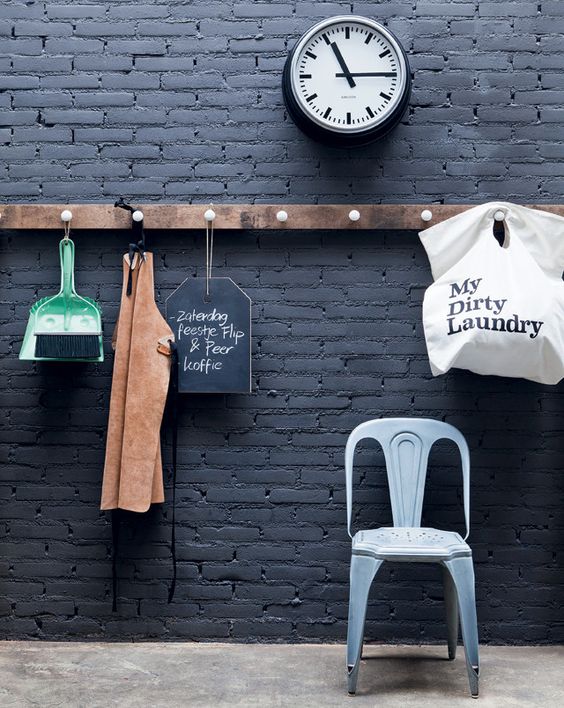 black brick wall with a wooden organizer and holder