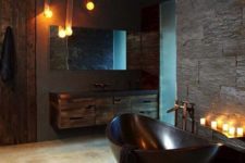 31 sexy masculine bathroom with a dark bathtub, dark tiles and wooden cabinets