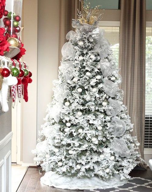 snowy tree with white ornaments and fabric garlands