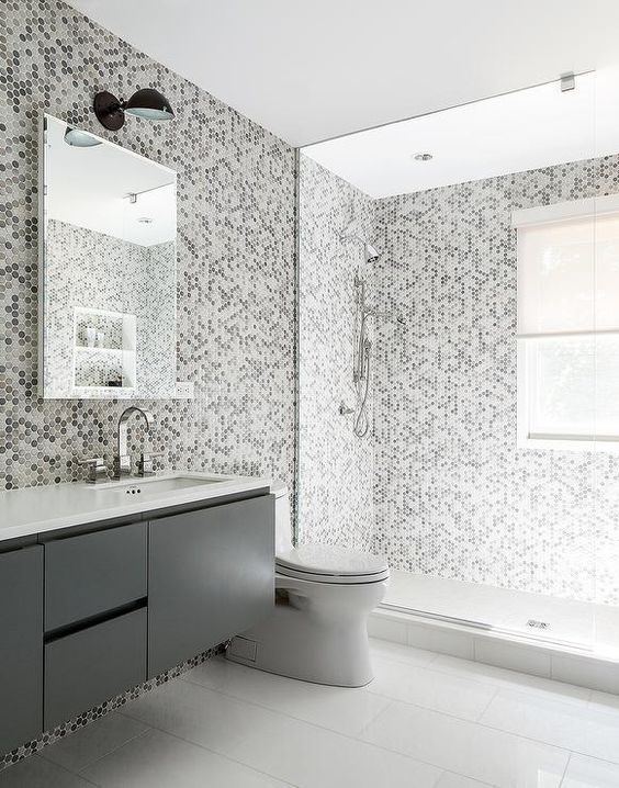 gray kids' bathroom features grey hex tiles on the wall and they continue to the shower