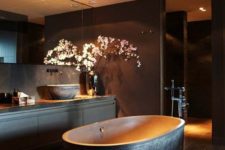 32 spacious dark bathroom, a free-standing bathtub with a textural look