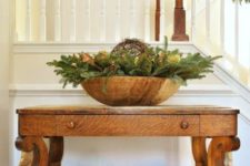34 large wooden bowl with fir branches and lights is enough to set up a mood