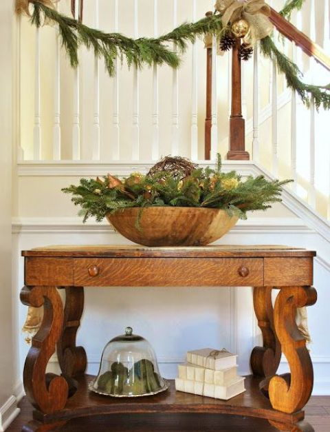 large wooden bowl with fir branches and lights is enough to set up a mood