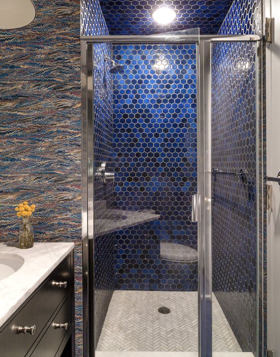 to add color to the shower, the designers used cobalt blue glazed hexagonal tiles