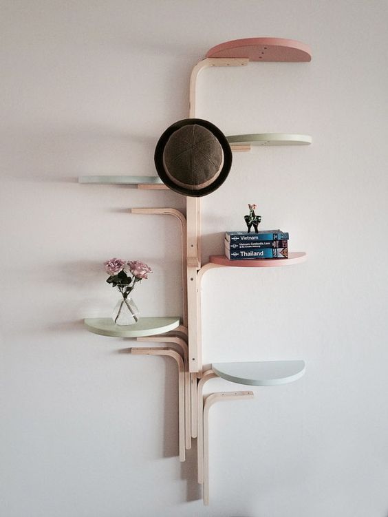wall-mounted shelf made of several stools and painted in pastel colors
