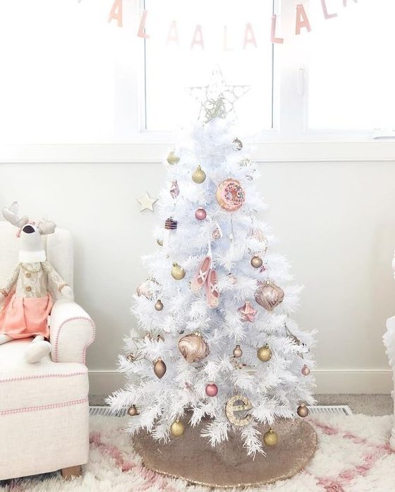 a Christmas tree with gold and pink ornaments is a cool and catchy idea for the holidays