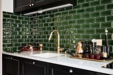 a bold black and white kitchen with glossy green subway tiles for a touch of color is very cool