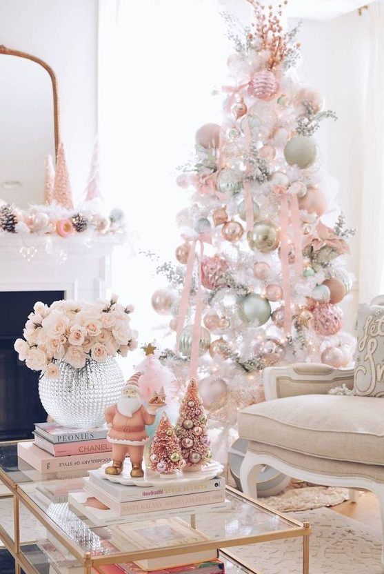 a charming white Christmas tree with pastel pink and green ornaments, ribbons and branches is a very catchy idea