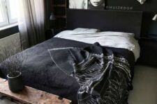 a stylish bedroom with black walls