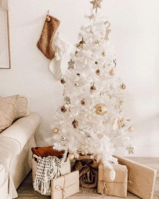 a glam white Christmas tree with gold ornaments and snowflakes looks very chic, beautiful and elegant