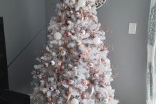 a glam white Christmas tree with pink, blush and white ornaments and pink ribbons is amazing