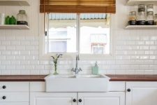 a neutral kitchen with farmhouse touches, rich stained wooden countertops and a white subway tile backsplash