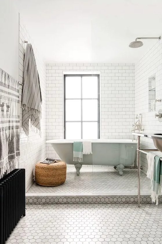 a peaceful space done with subway and hexagon tiles, accented with mint and wicker touches
