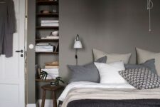 a relaxing grey bedroom – grey walls, dark stained furniture, grey and white bedding create a moody yet peaceful place to be