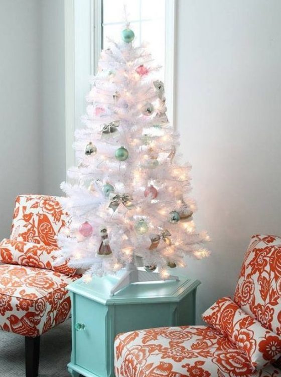 a small white Christmas tree decorated with pink and mint ornaments and lights is amazing for any pastel space