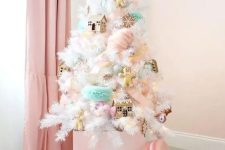 a small white Christmas tree decorated with pink, aqua, blush ornaments – houses, cookies, macarons and oversized ornaments looks amazing