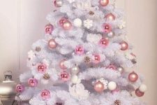 a very delicate white Christmas tree with pink, silver and pearl ornaments, pinecones and snowflakes