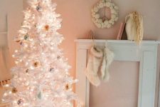 a white Christmas tree decorated with pastel and silver ornaments and lights looks very delicate, subtle and chic