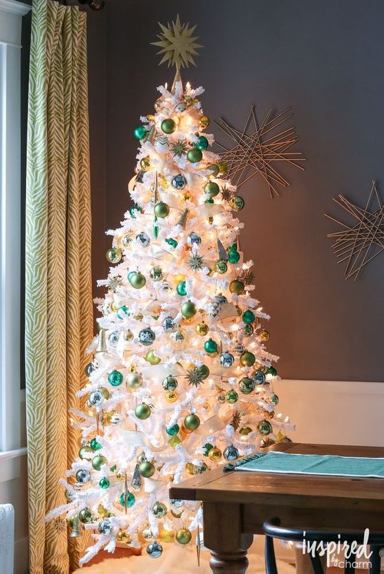 a white Christmas tree styled with green and light green ornaments and lights looks bold and contrasting