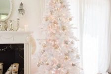 an echanting white Christmas tree with lights, gold and blush ornaments is a glam and chic solution