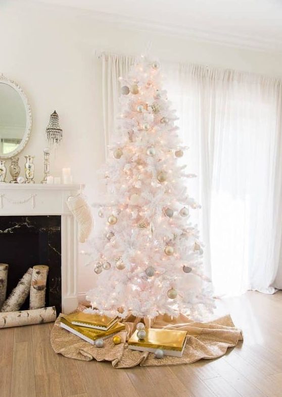 an echanting white Christmas tree with lights, gold and blush ornaments is a glam and chic solution