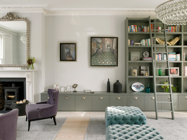 A classic Victorian living room design in shades of gray but with pastel color accents like turquoise ottomans and a olive green storage system. (STEPHEN FLETCHER ARCHITECTS)