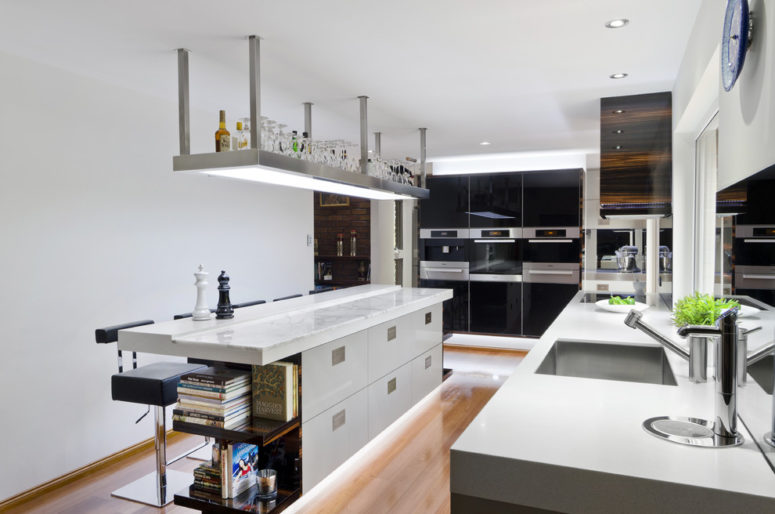 LED strip lighting under a kitchen island is a cool idea to make in a centrepiece of a kitchen (Darren James Interiors)