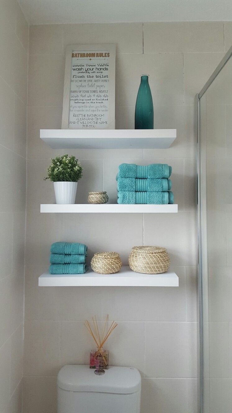 Lack shelves looks great over a toilet. Besides you can put as decor as towels and toilet paper on them.