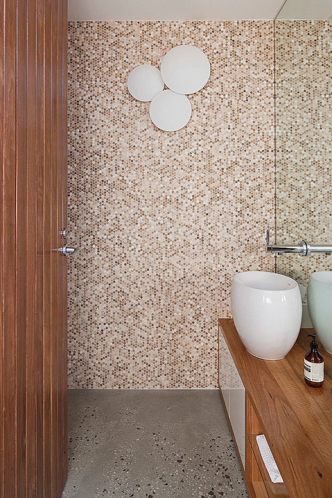 different shades of beige penny tiles looks beautiful on a shower's wall (bg architecture)