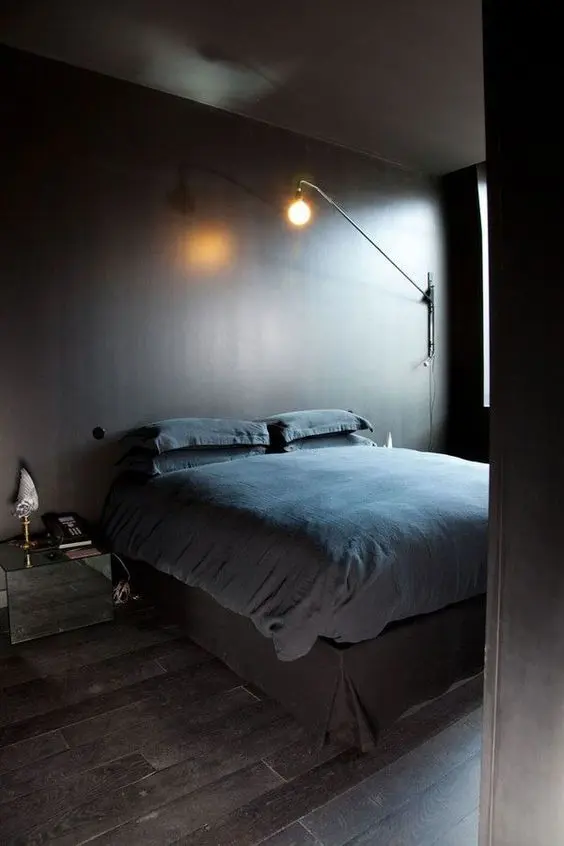 an ultra-minimalist moody bedroom in the shades of brown and grey with a mirror nightstand plus some cool lamps is lovely
