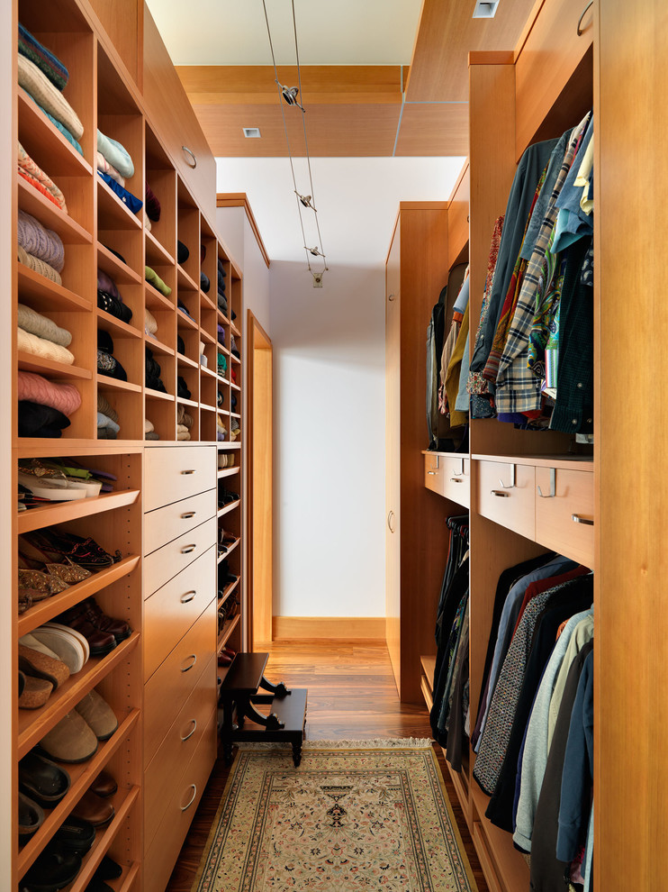 lots of drawers and sliding shelves are important for a narrow walk-in closet (Mike Knight Construction)