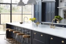 01 This chic vintage English kitchen features navy cabinetry and brass hardware
