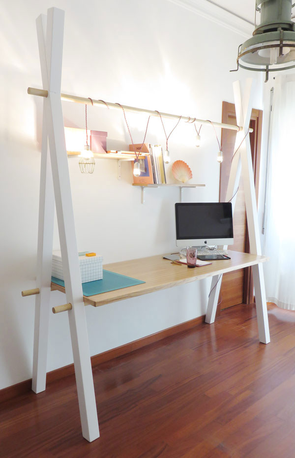 This simple modern desk by Tommaso Guerra is super functional and practical, it has crisscross legs and a holder