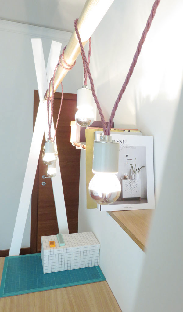 The desk leaves floor space unused and you can hang various lights, shelves and planters on the holder
