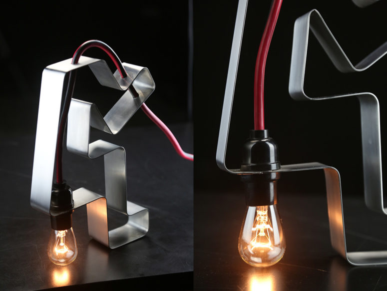 The piece is made of stainless steel and a red cord with a bulb, it features industrial design