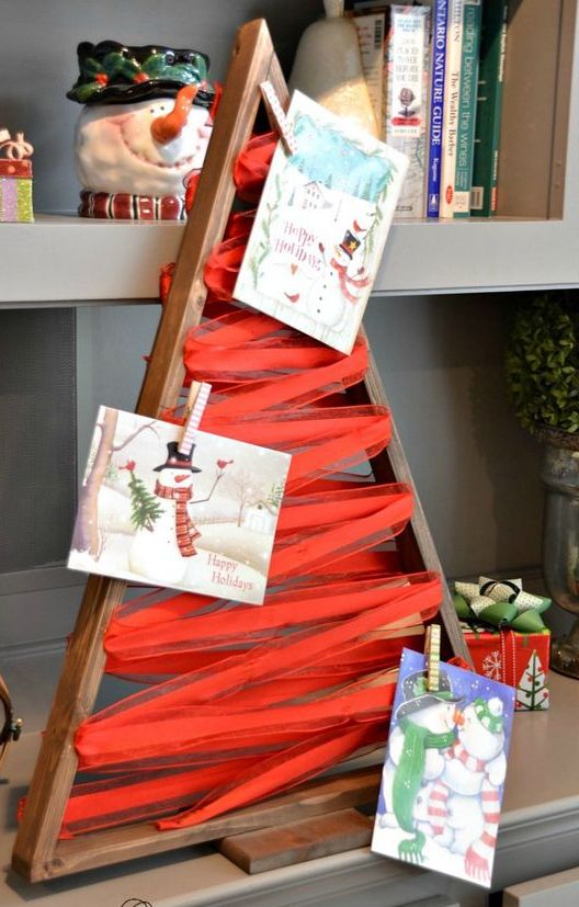 a wooden tree frame with ribbon for hanging cards