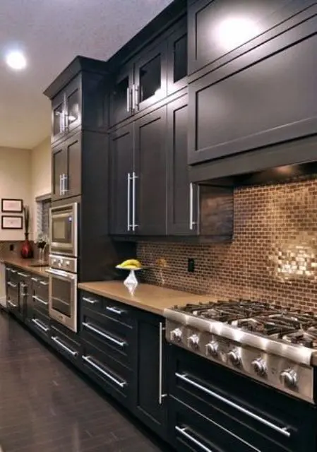 black kitchen with copper tile backsplash looks bold and chic