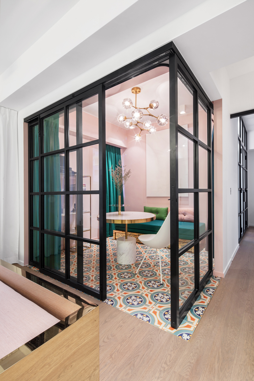 Suspended metal, double-sliding glass doors and dark jade drapery fully transform the level of privacy in the space