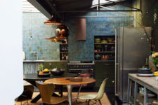 03 The moody kitchen is done with an industrial vibe, the blue and green tiles rule the space