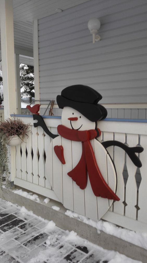 a snowman made of plywood and board can be a nice decoration for outdoors