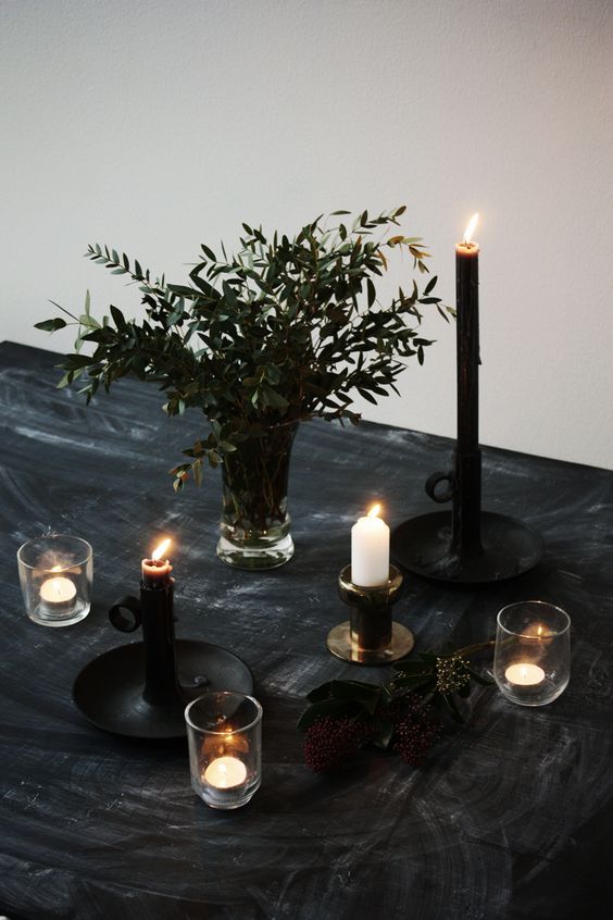 charcoal black tablecloth, greenery and candles