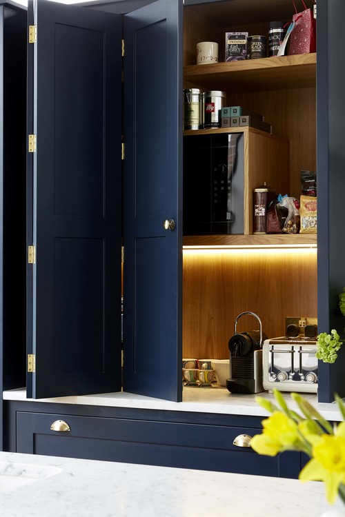 The cabinets hold the appliances and are lit up inside for comfort