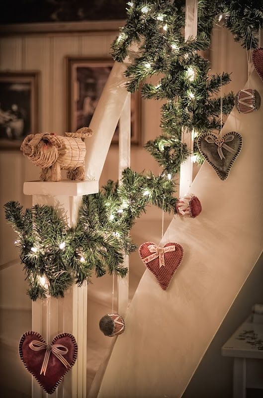 cute fir garland with lights and sewn hearts hanging